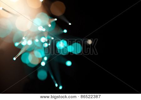 Incoming light through fiber optics abstract background. Soft focus, bokeh background. Intentionally shot with lens flares.