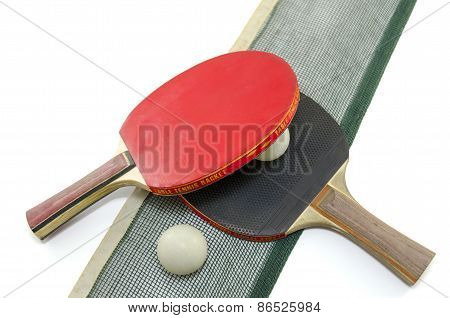 Two Table Tennis Rackets And A Net Isolated