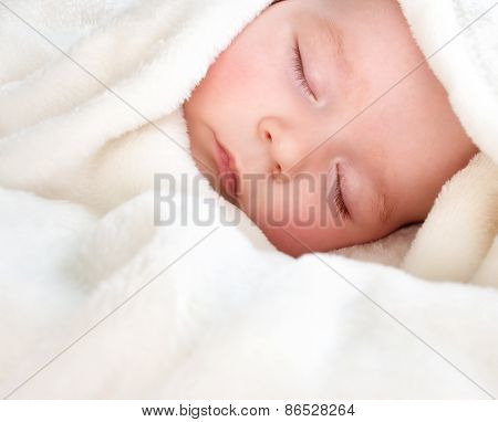 Baby sleeping covered with soft blanket