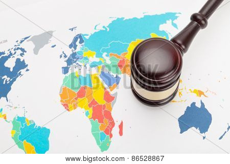 Wooden Judge's Gavel And Calculator Over Some Financial Documents