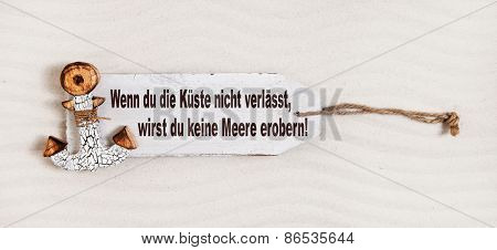 German slogan on a wooden sign with anchor with the text: if you don't leave coasts you can not discover the oceans. Concept for courage.