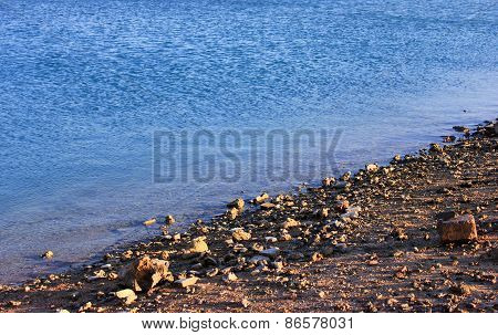 Sea Beach At Sunset. Sea Blue Water Background.