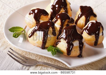 Delicious Profiteroles With Cream And Chocolate Glaze
