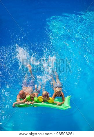 Family Outside Relaxing In Swimming Pool on a lilo
