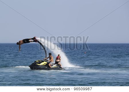 Unidentified Turkish Man Demonstrates Flyboard Acrobatics On The Beach Of Camyuva