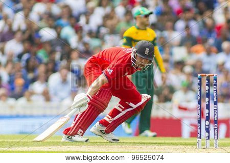 LONDON, ENGLAND - June 19 2013: Sweat pours from Jonathan Trott's helmet as he runs a single during the ICC Champions Trophy semi final between England and South Africa at The Oval Cricket Ground