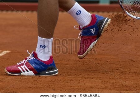 MONTE CARLO, MONACO. APRIL 18 2012 Novak Djokovic (SRB) clears clay off his training shoes during the second round match with Andreas Seppi (ITA) at the ATP Monte Carlo Masters 