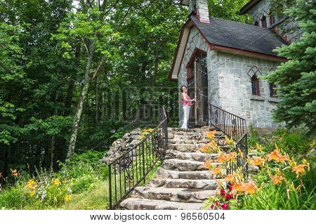 woman entering stone house