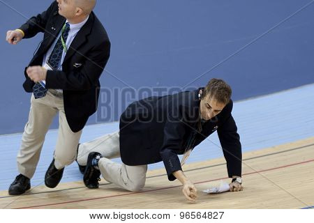 LONDON, ENGLAND. FEBRUARY 18 2012: Officials check the track after a crash at the UCI Track Cycling World Cup at the London Velodrome, Queen Elizabeth 2nd Park