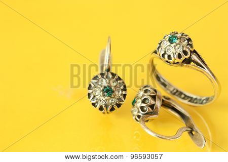 Women's earrings and a ring of white metal and green stones