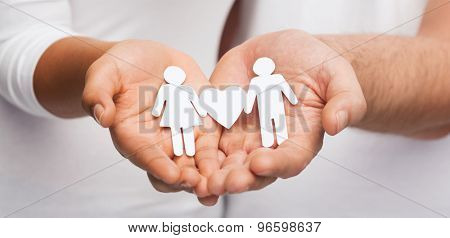relationships and love concept - clousup of couple hands showing couple with heart shape