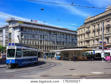 Zurich, Switzerland - 14 May, 2015: people, trams and buildings on Paradeplatz square, view from Bahnhofstrasse street. Paradeplatz is a square in Zurich, one of the most expensive pieces of real estate in Switzerland.