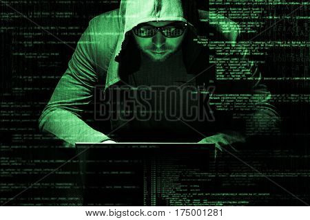 Internet concept. Hacker working on a code on dark digital background with digital interface around.