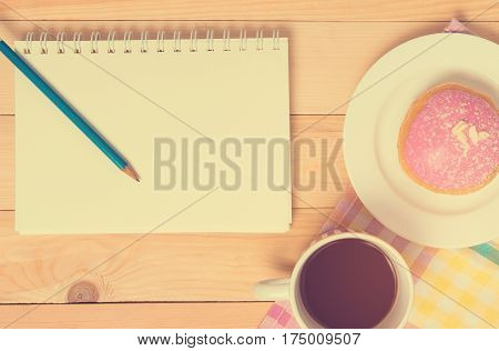 Blank notebook on breakfast vintage cafe table