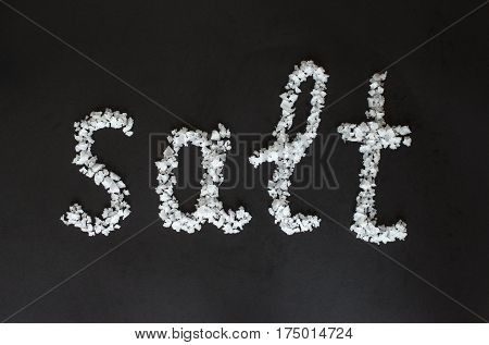 Text Salt from a large sea salt on black background.