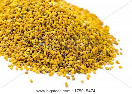Plant based Organic bees pollen on a white background shot with narrow depth of field room for copy space and text