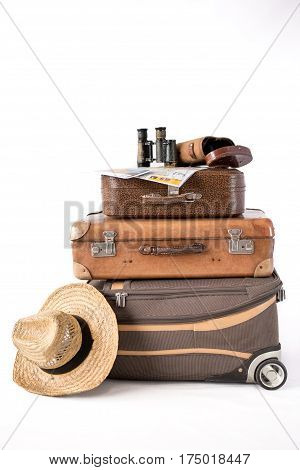 Vintage and modern suitcases binoculars and hat. Concept of travel.