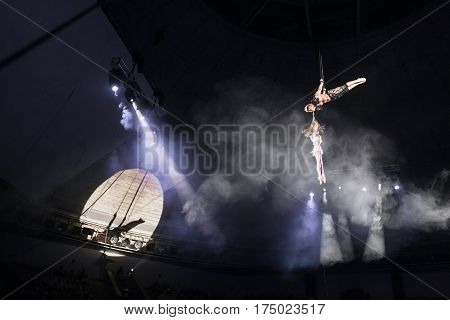 Stunt aerialists men and women in the circus. Love, danger, and romance concept.