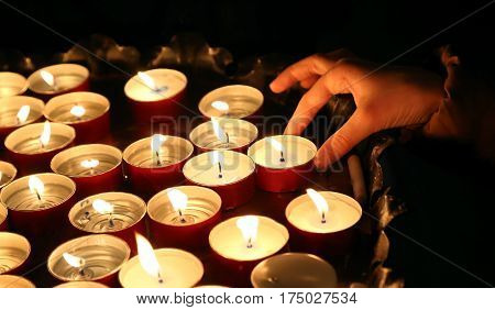 Child Lights A Candle During The Religious Ceremony