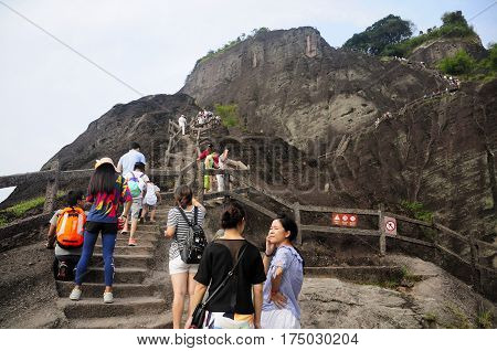 September 3 2016. Wuyi China. Chinese tourists climbing up the stone steps up to the top of the Mount Wuyi Scenic area in Fujian province China.
