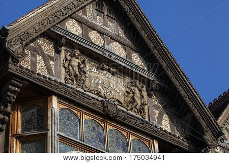 A close-up of the sculptured plaque on the facade of The Beaney House of Art and Knowledge in Canterbury England.