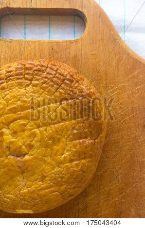 head of traditional Adygei cheese handmade on wooden Board