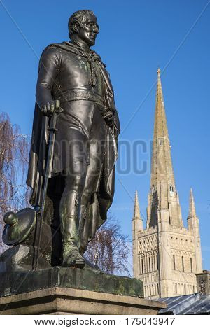 A statue of the Duke of Wellington with the beautiful Norwich Cathedral in the background in the historic city of Norwich UK.