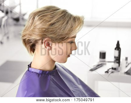 Young woman with trendy hairstyle at beauty salon