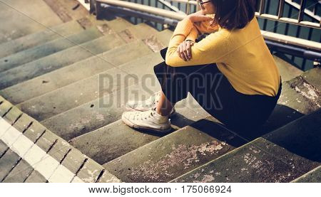 Girl with Glasses Yellow Sweater Sitting on the Stairs