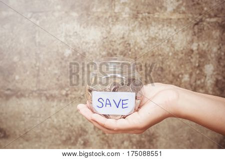 Close up saving a bottle in woman's hand