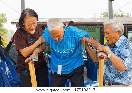 CHIANG RAI THAILAND - FEBRUARY 20 : unidentified couple helping leprosy asian old man on February 20 2016 in Chiang rai Thailand.