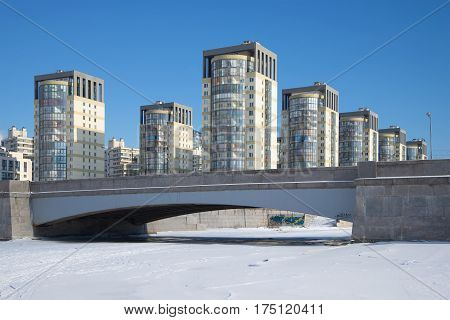 Smolensky bridge and body of a modern residential complex, sunny day in February. Winter Saint-Petersburg