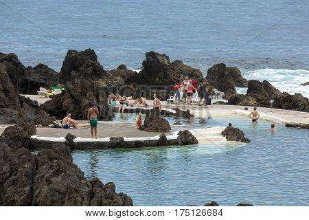 PORTO MONIZ MADEIRA PORTUGAL - SEPTEMBER 5 2016: Natural rock pool of Porto Moniz. It is a public bath with water from the Atlantic Ocean.