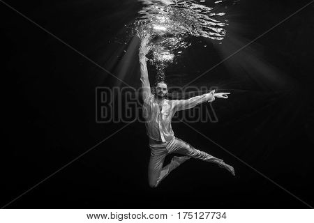 A Young Male Ballet Dancer Posing Underwater