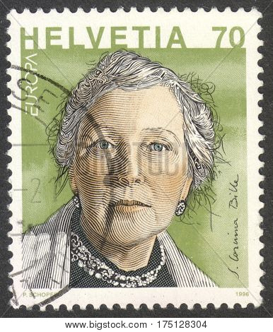 MOSCOW RUSSIA - CIRCA FEBRUARY 2017: a post stamp printed in SWITZERLAND shows a portrait of Corinna Bille (1912-79) a writer the series 