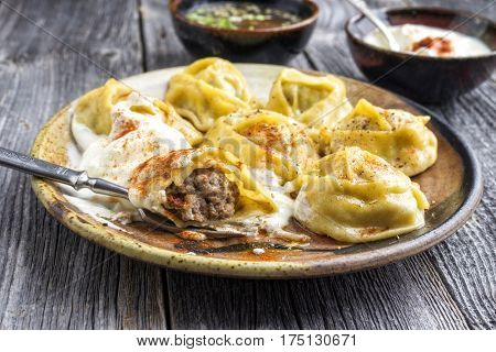 Traditional Turkish Manti with Joghurt and Vinegar as close-up on a plate