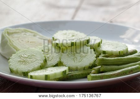 cabbage, cucumber and yardlong Vegetable side dish on white plate