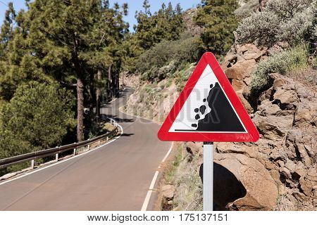Road sign falling stones, Traffic sign caution possible falling rocks from the mountains