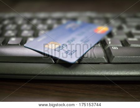 Close up of credit card on a computer keyboard. Concept of internet purchase