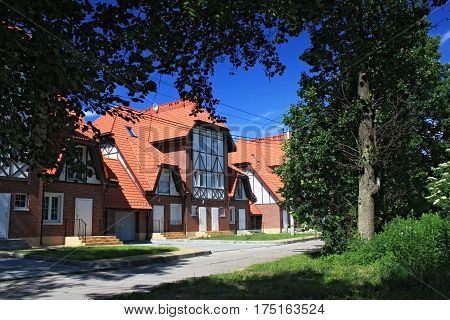 MORSKOE, KALININGRAD REGION, RUSSIA - JUNE 19, 2011: New cottages in the style of half-timbered houses in the Morskoe (Pillkoppen) village in the Curonian Spit National Park. Russia.