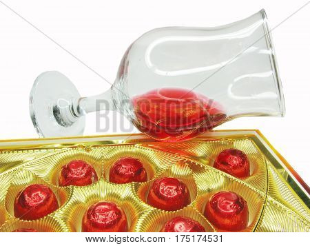 red wine in glass goblets and chocolate sweets
