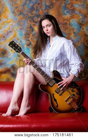 Podolsk, Russia - February 21, 2017: Young brunette girl with a vintage electric guitar Gibson es-345 1969 model year