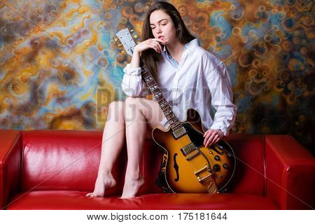 Podolsk, Russia - February 21, 2017: Young brunette girl with a vintage electric guitar Gibson es-345 1969 model year