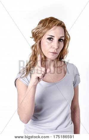portrait of attractive blond woman staring intense with angry and defiant eyes in disappoint face expression and angry emotion isolated on white background pointing with finger