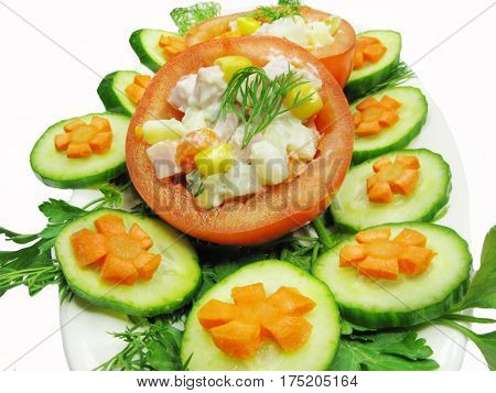stuffed red tomato with cucumber carrot and parsley