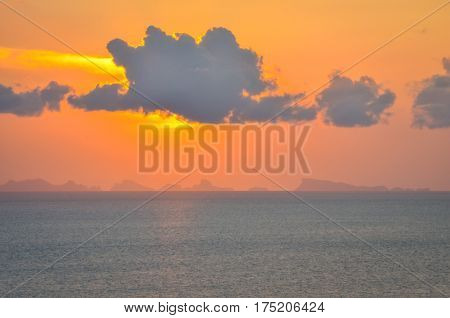 perfect sun hides behind clowds dramatic and colorful sunset at beach