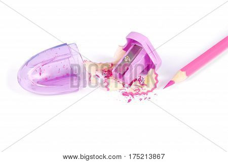 Purple plastic pencil sharpener with red pencil white background with soft shadow