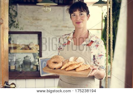 Woman with bread at pastry shop order