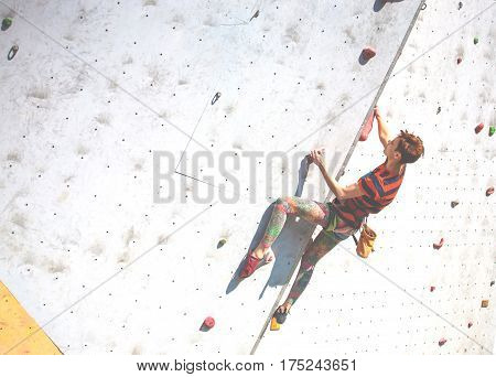 The Girl Climbs On The Climbing Wall.