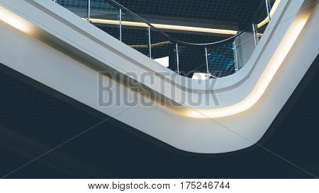 Contemporary spaces of public place. Mezzanine with glass balcony railing. Ceiling lighting in a modern building. Griliato ceiling